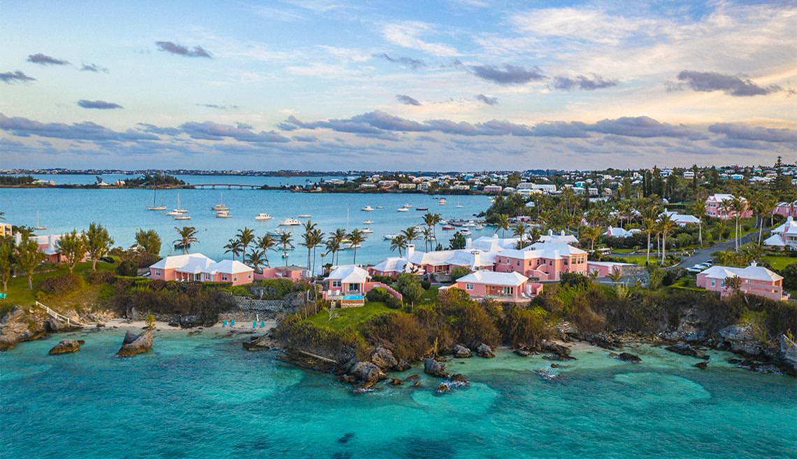Pink Bermudian cottages along the harbour at dusk